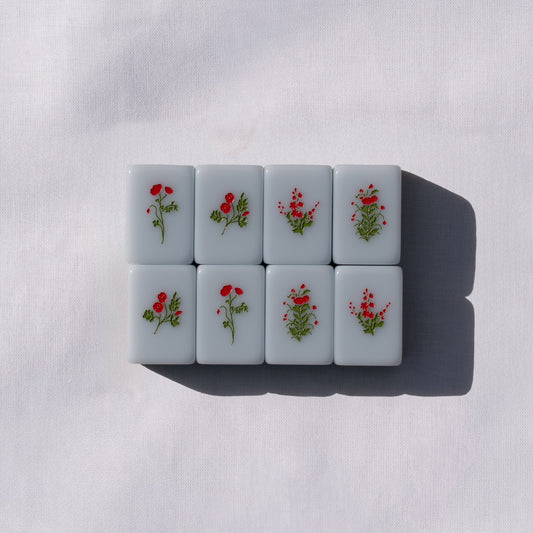 Set of light blue mahong tiles with flower icons.