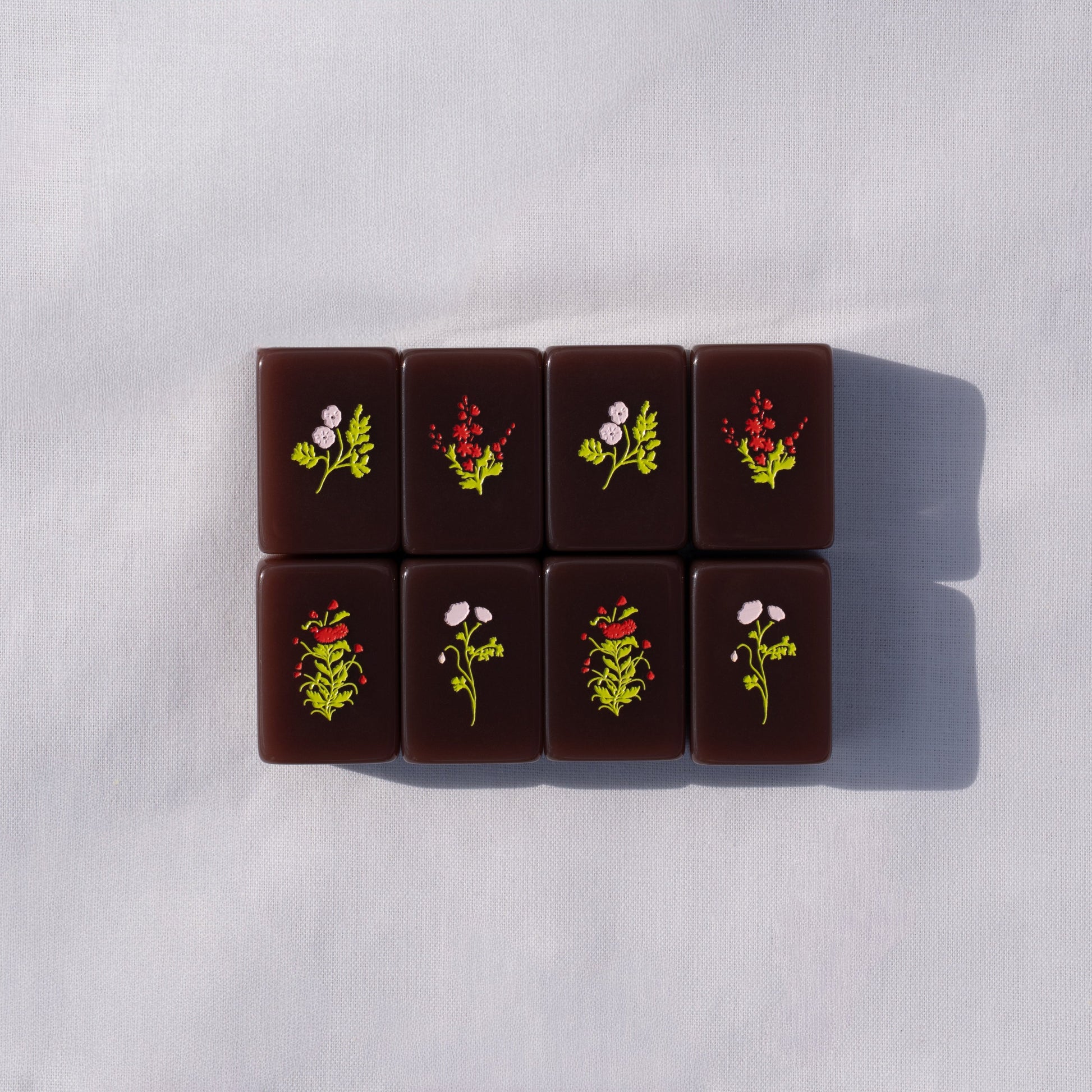 chocolate brown mahjong tiles with flower designs