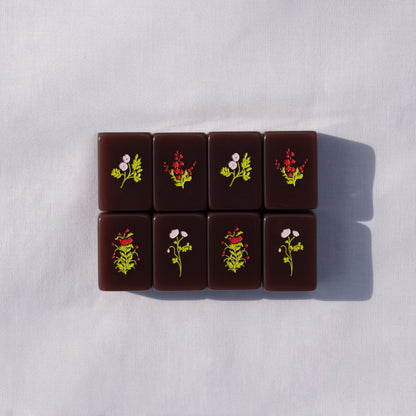 chocolate brown mahjong tiles with flower designs